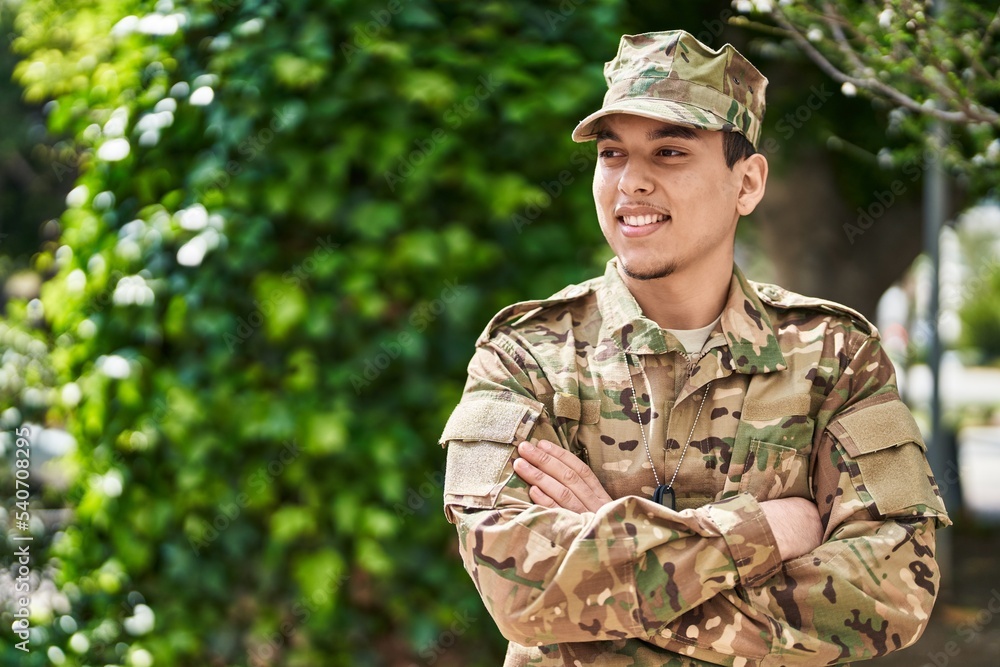 Young man army soldier standing with arms crossed gesture at park