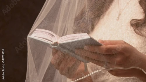 Jewish woman reading scripture under her vail photo