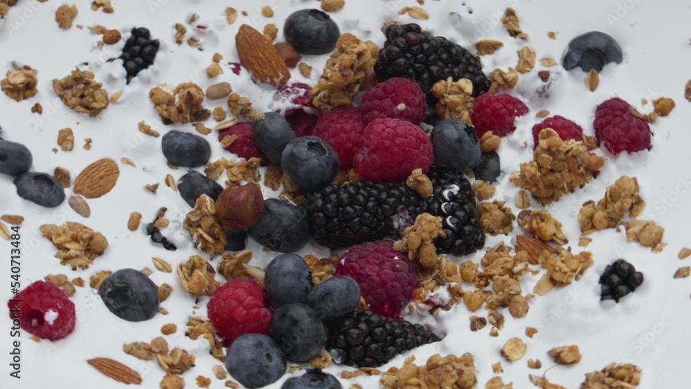 Healthy berry crunchy breakfast with natural yogurt in super slow motion closeup Healthy berry crunchy breakfast with natural yogurt in super slow motion closeup