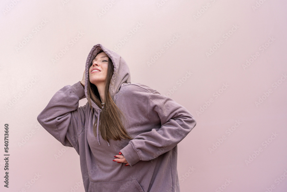 Woman with eyes closed dancing in front of pink wall Woman with eyes closed dancing in front of pink wall