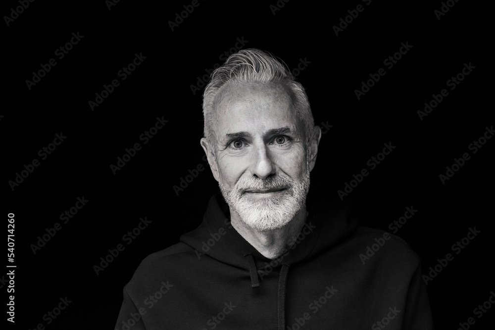 Smiling mature man against black background Smiling mature man against black background