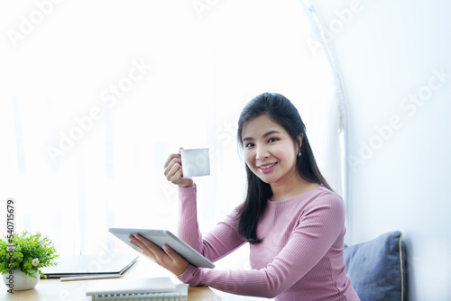 Portrait of a beautiful Asian teenage girl using a tablet computer