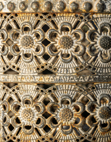 Antique carved metal background with floral patterns