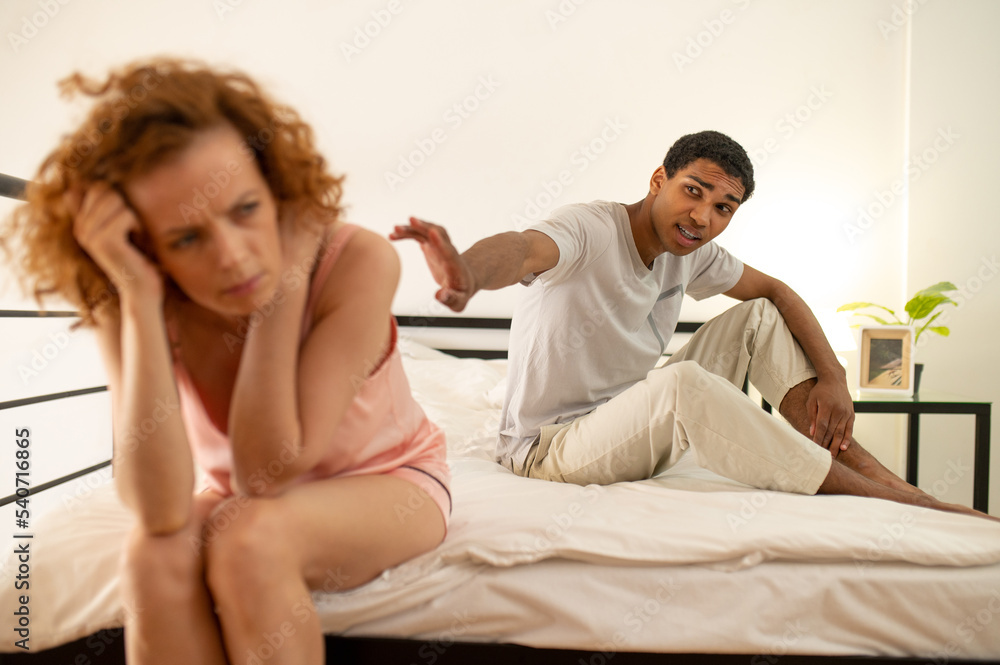 Married couple having an argument an both looking stressed Married couple having an argument an both looking stressed