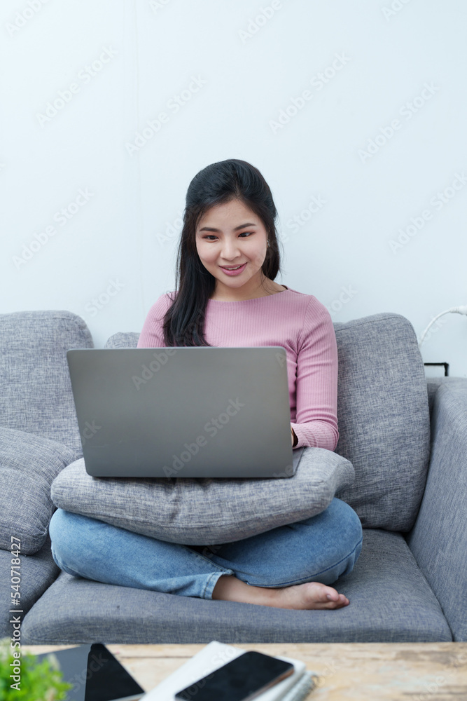 Portrait of a beautiful Asian teenage girl using a computer Portrait of a beautiful Asian teenage girl using a computer