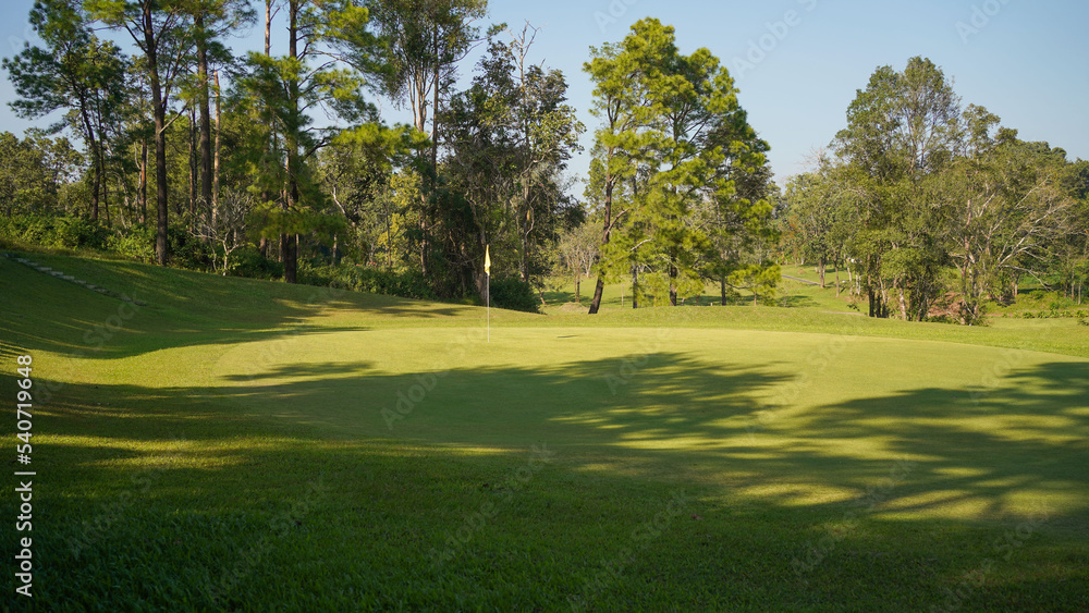 Beautiful golf course in a sunny day. Background evening golf course has sunlight shining down. Golf course in the countryside