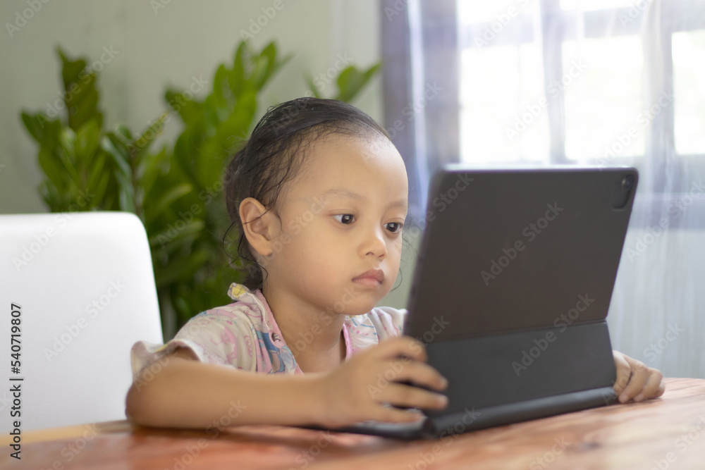 Asian girls watch online media at home, happy young girls Asian girls watch online media at home, happy young girls