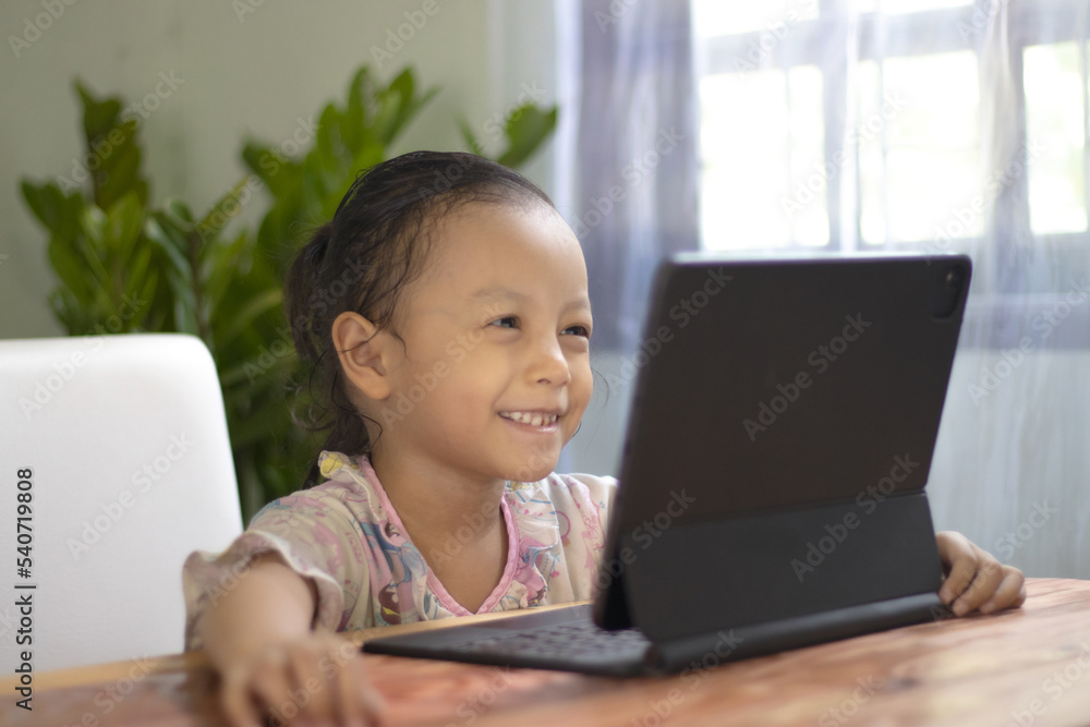 Asian girls watch online media at home, happy young girls Asian girls watch online media at home, happy young girls