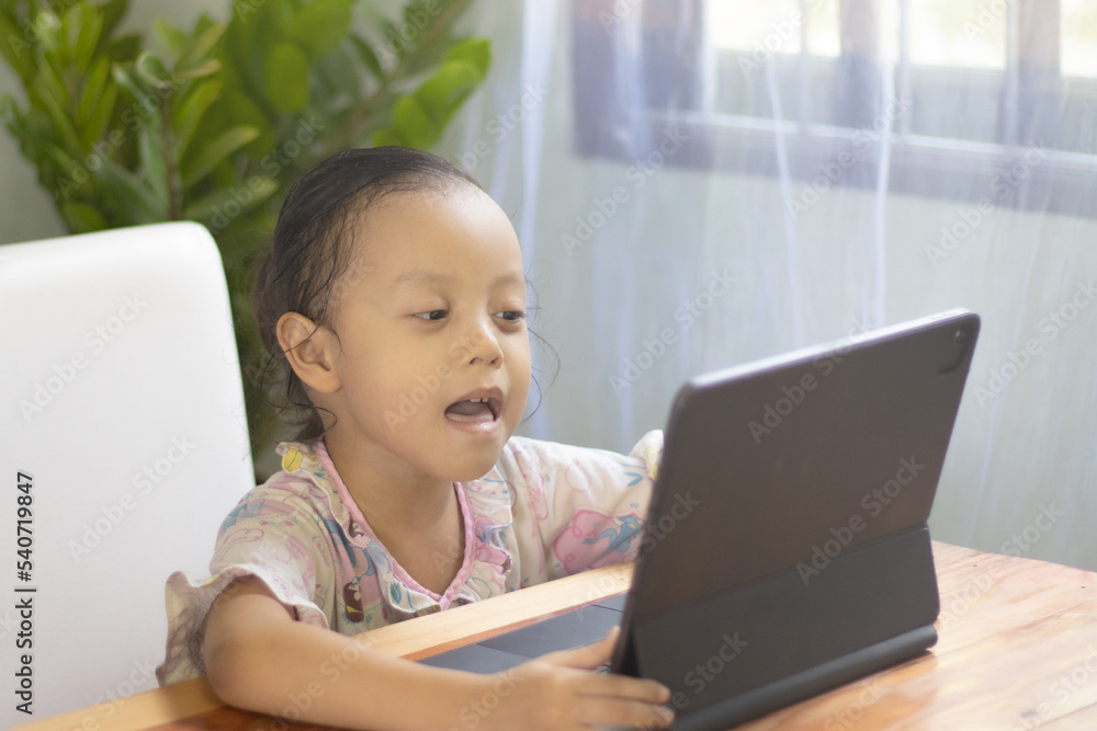 Asian girls watch online media at home, happy young girls Asian girls watch online media at home, happy young girls