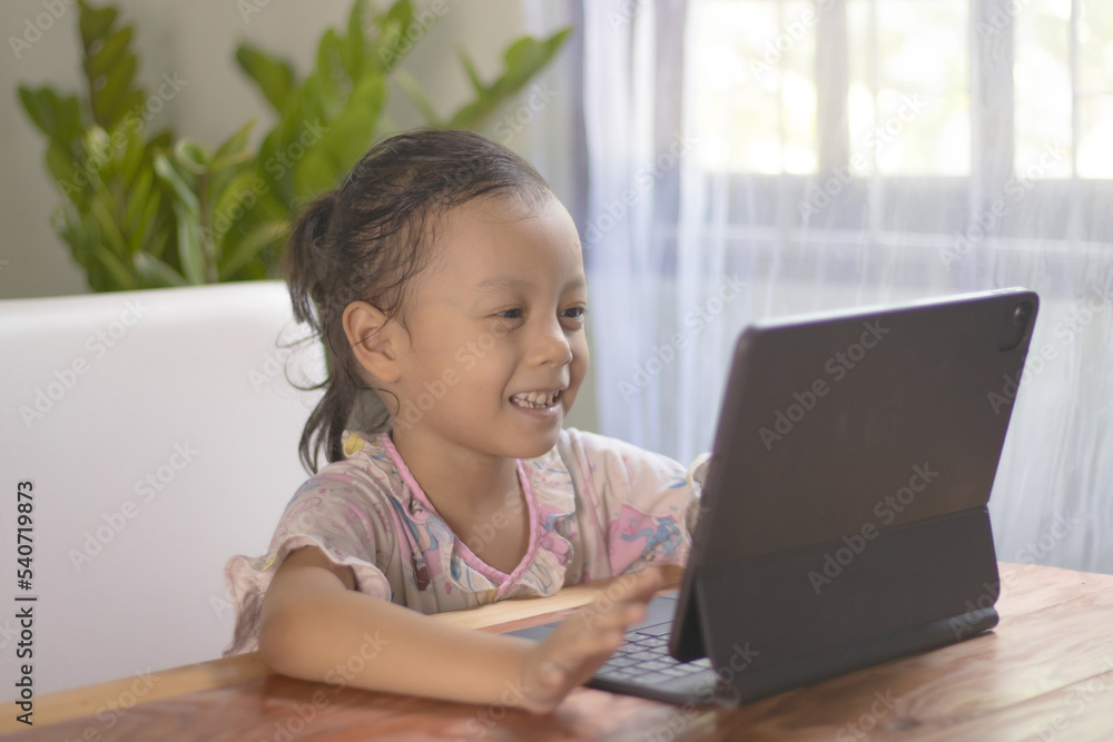 Asian girls watching online media at home are happy. Asian girls watching online media at home are happy.