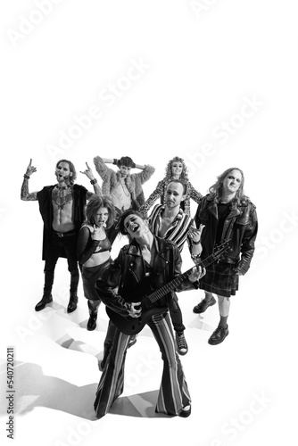 Group of stylish expressive people, man and woman, rock musicians performing, playing. Black and white photography