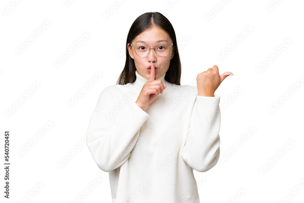 Young Asian woman over isolated background pointing finger to the laterals and happy Young Asian woman over isolated background pointing finger to the laterals and happy