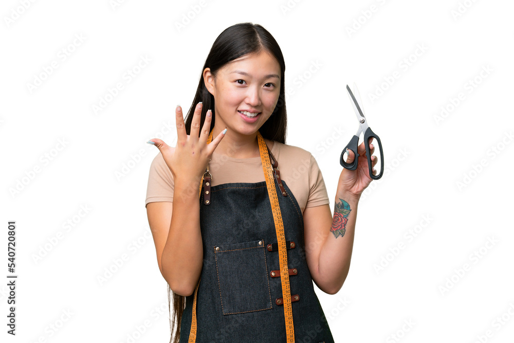 Young Asian seamstress woman over isolated background counting five with fingers Young Asian seamstress woman over isolated background counting five with fingers