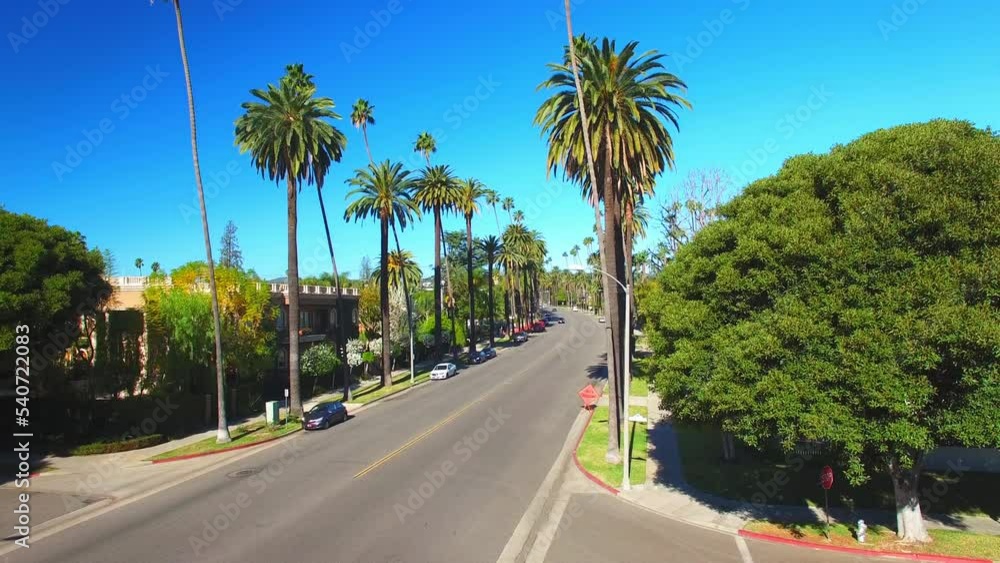 Aerial Upward Shot Of Road Amidst Residential Houses In City Against Clear Sky - Beverly Hills, California Aerial Upward Shot Of Road Amidst Residential Houses In City Against Clear Sky - Beverly Hills, California