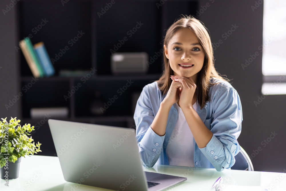 Portrait of a businesswoman using laptop in office Portrait of a businesswoman using laptop in office