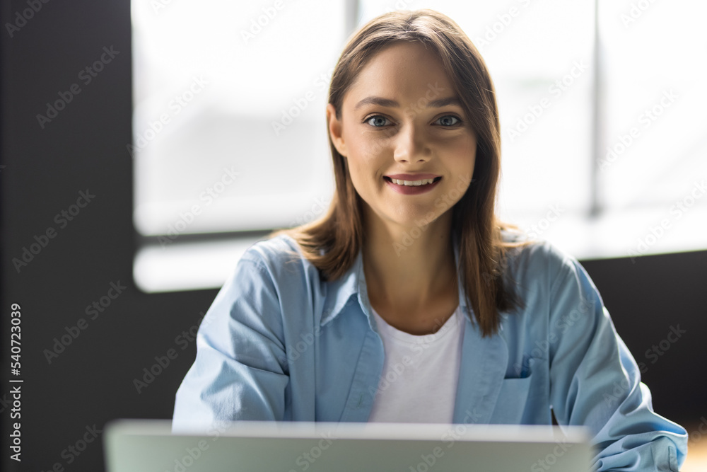 Happy young woman working with laptop at home office Happy young woman working with laptop at home office