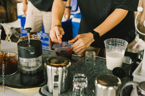 preparing, brew or pouring into a glass of milk to set the iced cocoa on the table with the coffee-making equipment. Selective, soft focus