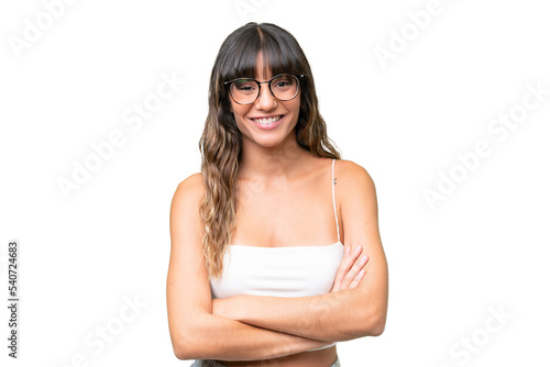 Young caucasian woman over isolated background keeping the arms crossed in frontal position