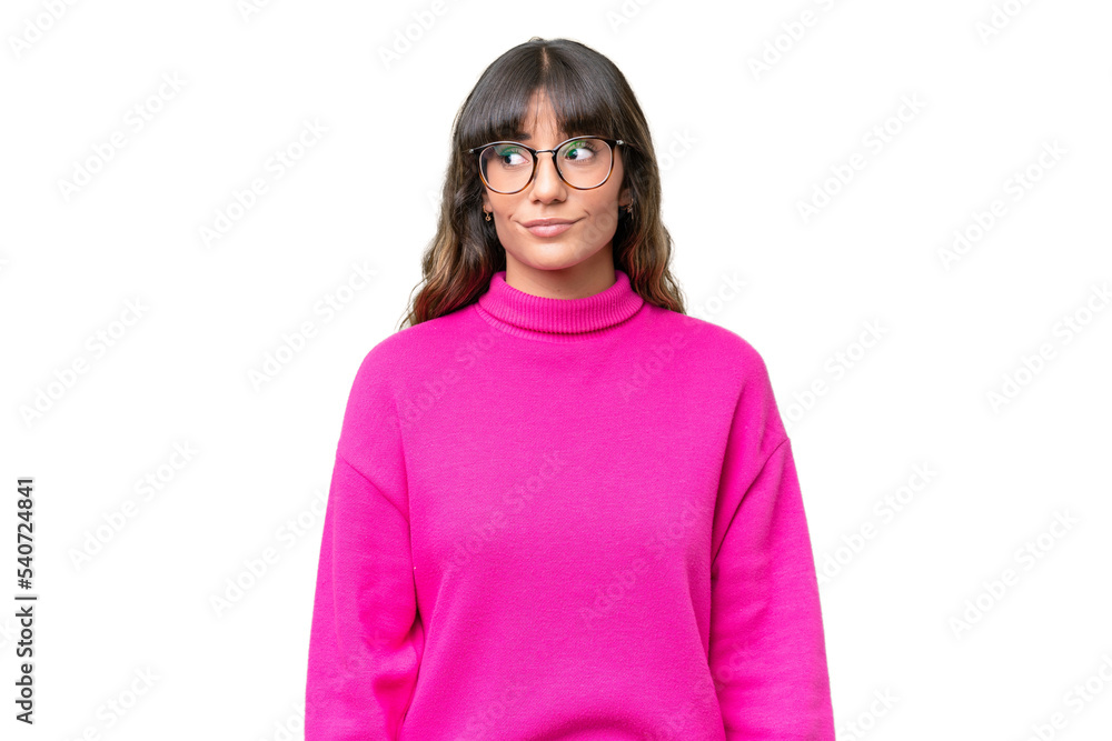Young caucasian woman over isolated background making doubts gesture looking side Young caucasian woman over isolated background making doubts gesture looking side