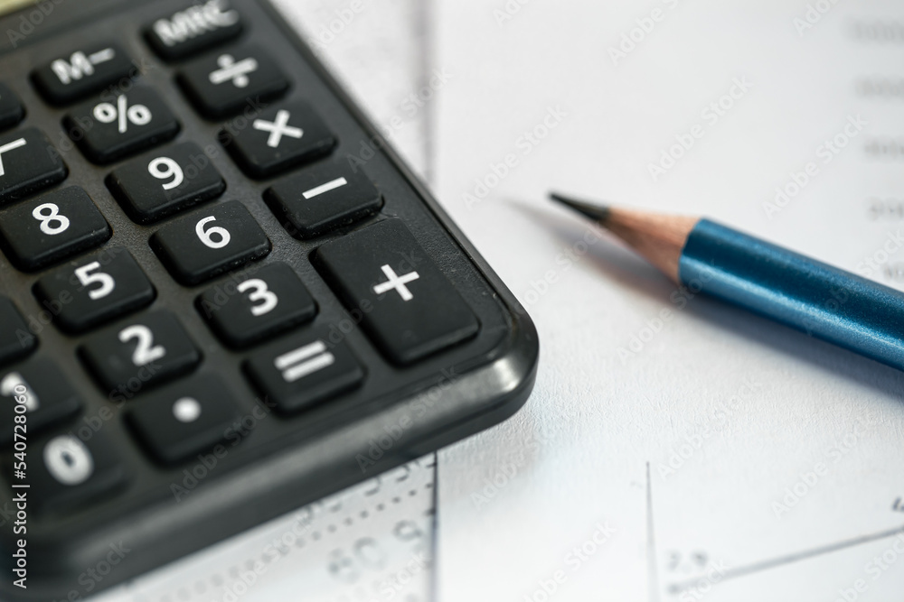 Calculator and pencil close-up on a blurred background. Calculator and pencil close-up on a blurred background.