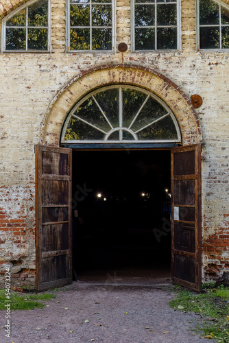 Dark doorway with wooden doors on old brick building