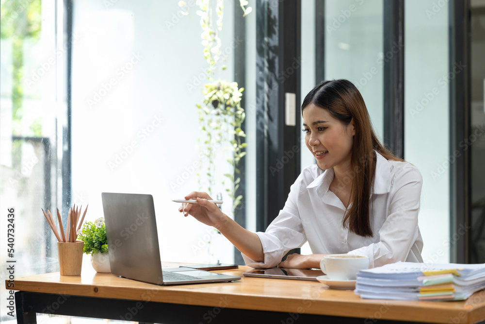Young business asian woman working on laptop computer. Young business asian woman working on laptop computer.