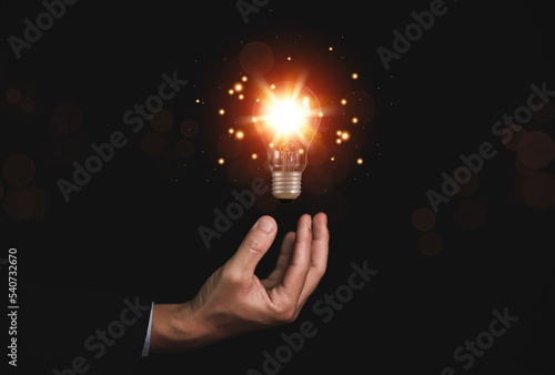 businessman holding a light bulb Digital technology. imagine an idea Creative and innovative. brain to brainstorm ideas in business.	
