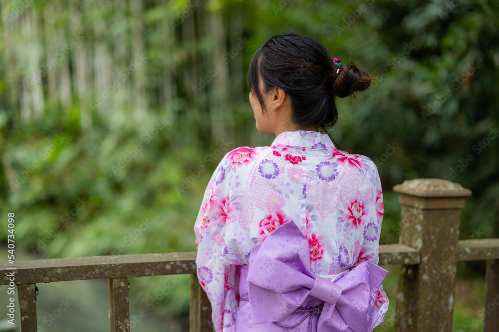 Rear view of woman wear yukata in the park Rear view of woman wear yukata in the park