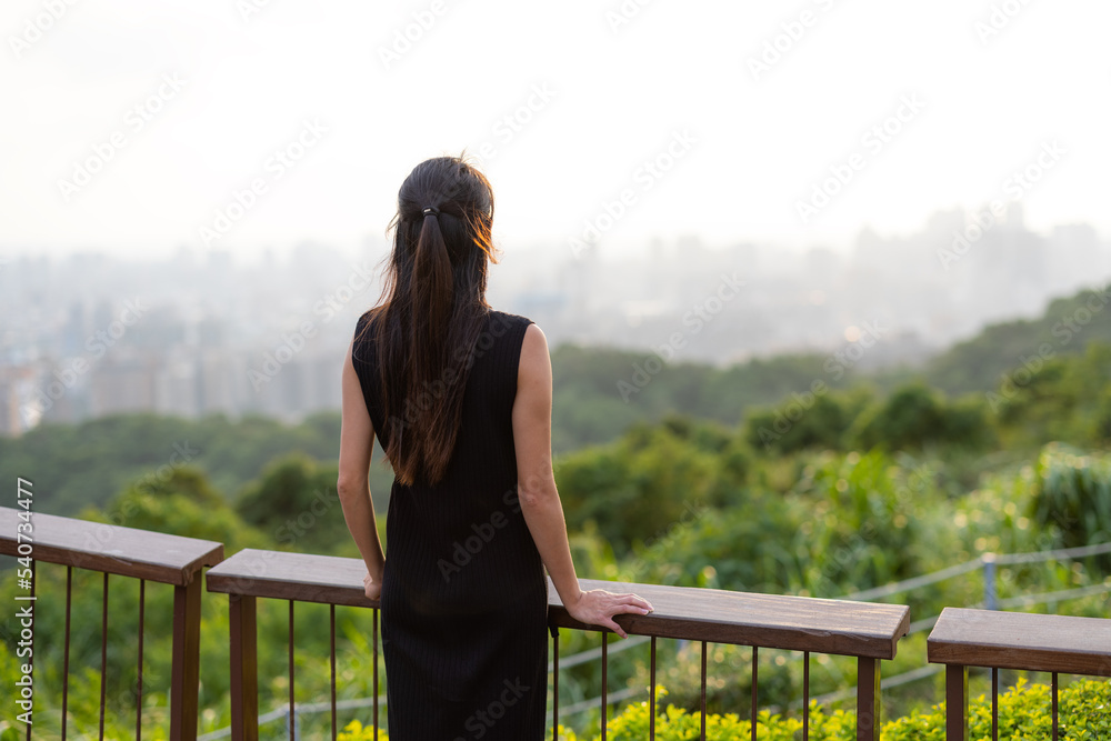 Woman look at the city on mountain