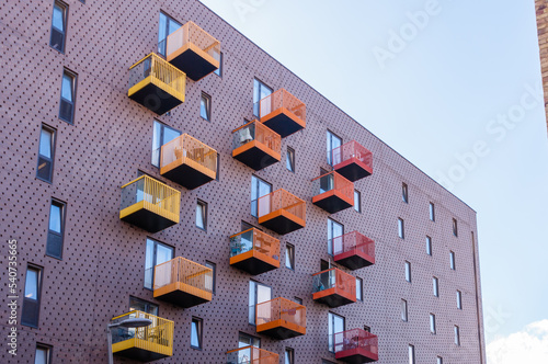 London, England, United Kingdom, 9 October 2022: Bright colourful building materials on apartment block balconies in housing development in modern block of homes in East London flats