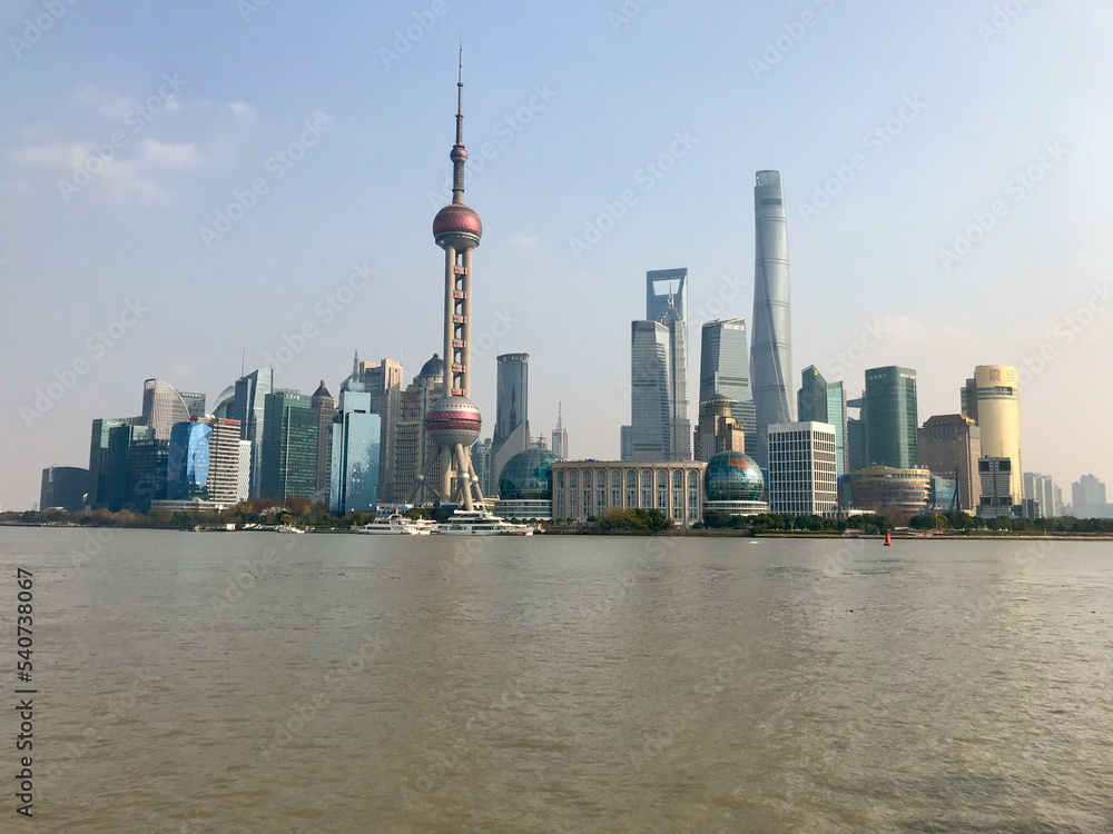 Shanghai, China, November 2016 - The Bund over a body of water with a city in the background