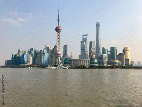 Shanghai, China, November 2016 - The Bund over a body of water with a city in the background