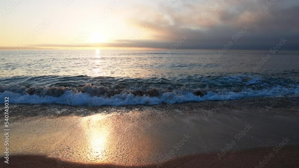 Black Sea and beach nearby against a sky with clouds and a dawn sun Black Sea and beach nearby against a sky with clouds and a dawn sun