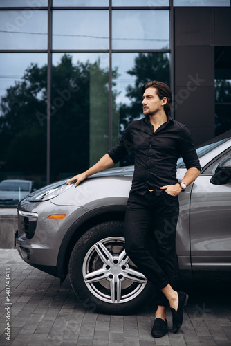 Handsome man standing by his new car © Petro