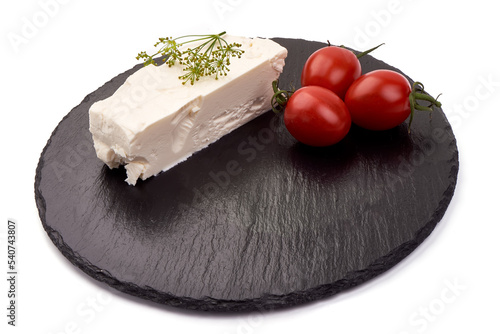 Soft feta chease on black slate stone plate with tomatoes cherry and dill herbs. Isolated on vhite background. photo