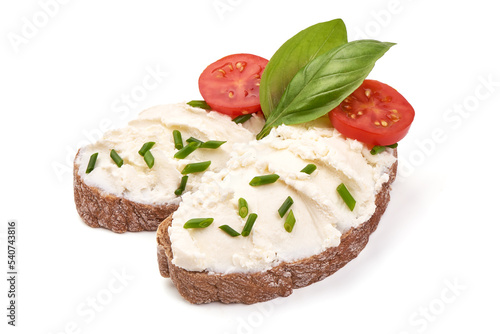 Sandwiches with soft cream cheese Feta, with cherry tomatoes and basil leaves. Isolated on white backgroun.
