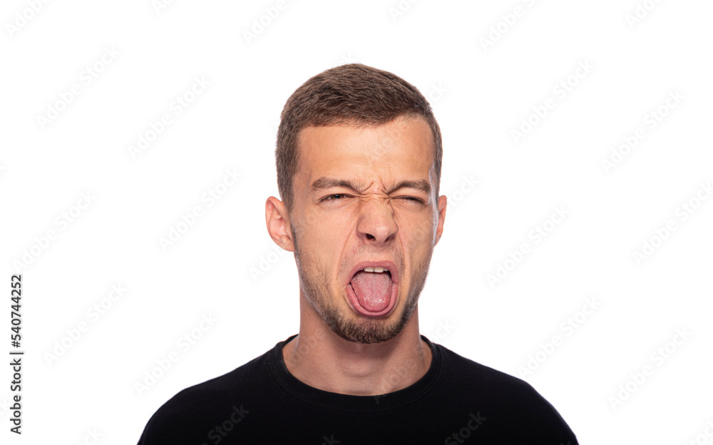 Fototapeta premium A young man and makes a disgusted grimace on a white background.