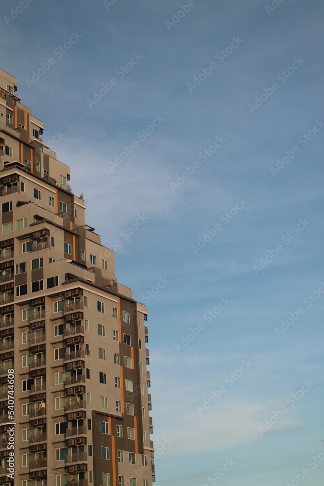 Building in the city. Modern luxury apartment building in Thailand. Modern residential condominium building on blue sky background.