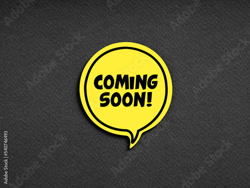 The message coming soon on yellow speech bubble or balloon. Business marketing advertisement communication announcement photo