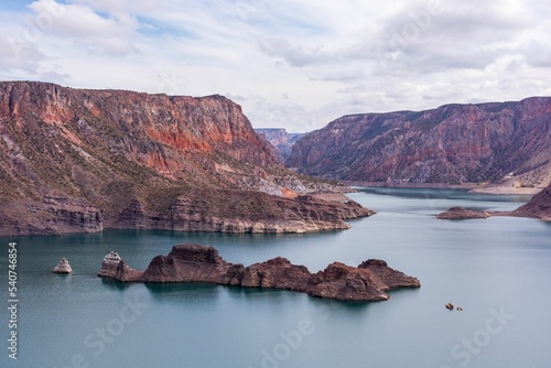 Cinematic lake surrounded by red cliffs in Provincia de Mendoza, Argentina photo