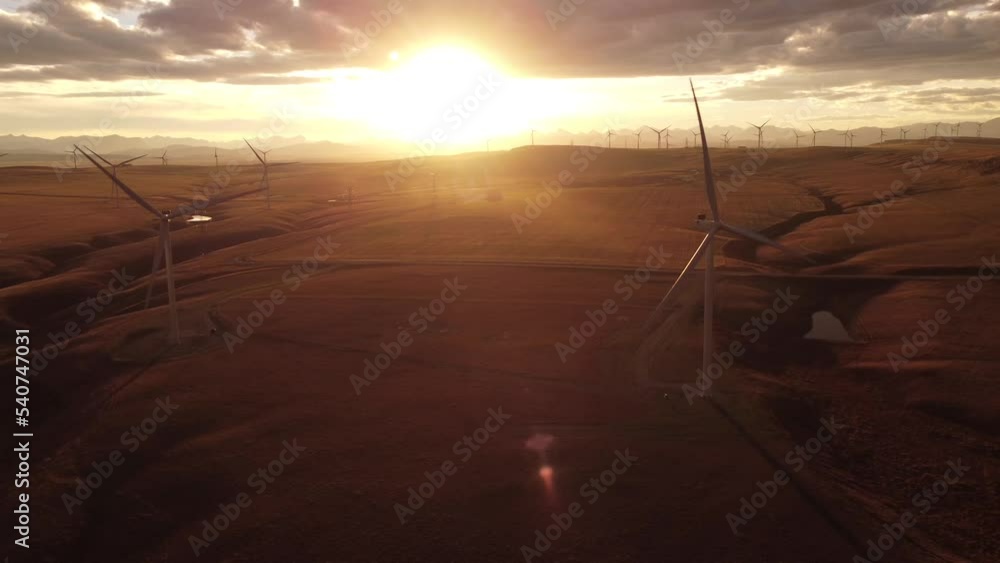 Aerial Windmills cinematic flight at sunset with distant Rocky Mountains near Pincher Creek Alberta Canada
Aerial Windmills cinematic flight at sunset with distant Rocky Mountains near Pincher Creek Alberta Canada