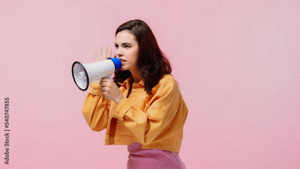 angry woman making announcement in loudspeaker isolated on pink angry woman making announcement in loudspeaker isolated on pink