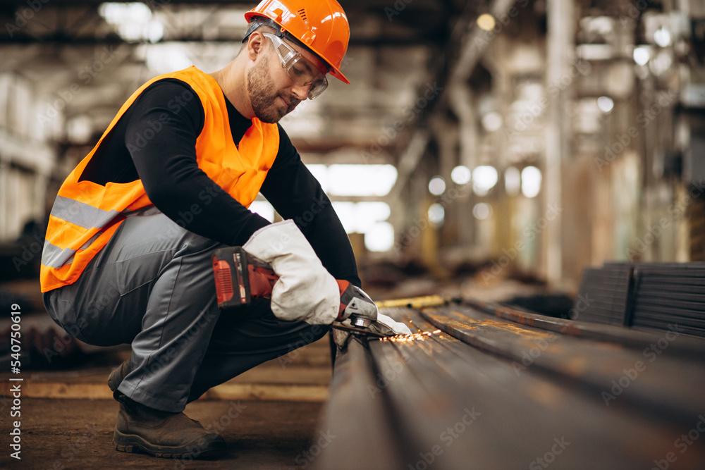 Man cutting steel at the factory Man cutting steel at the factory