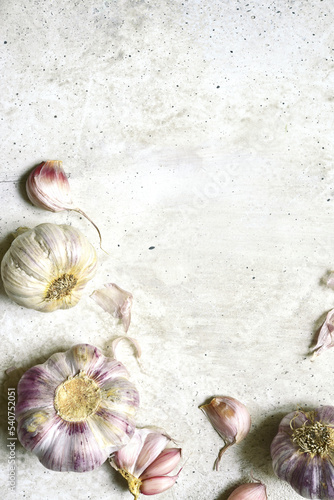 Culinary background with bulbs of garlic. Top view with copy space.