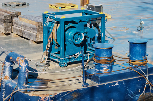 Wallpaper Mural Ship anchor windlass. Electric deck mechanism for raising and lowering the anchor on the anchor chain. Winch with blue steel rope. Sunny day at the port Torontodigital.ca