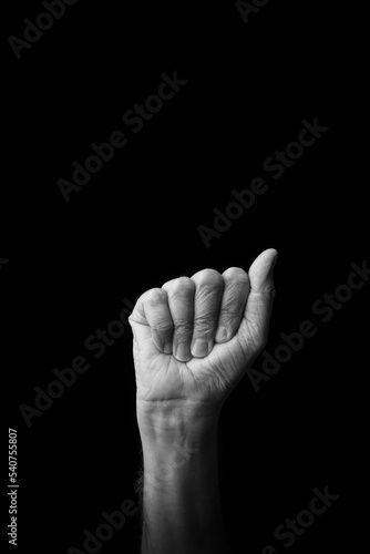 Hand demonstrating the Japanese sign language letter 'A' or '.ぁ' with copy space