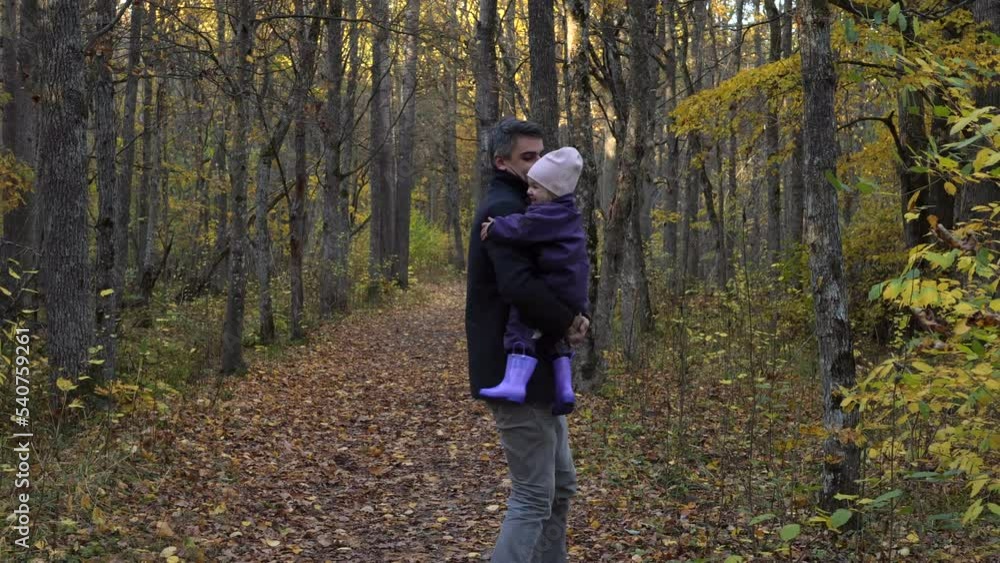 Father playing with his daughter in the park enjoying autumn nature. Father playing with his daughter in the park enjoying autumn nature.