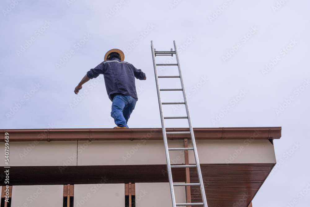builder worker team working walking on roof for set install solar cell roof top . High aluminium stairs use for work builder worker team working walking on roof for set install solar cell roof top . High aluminium stairs use for work