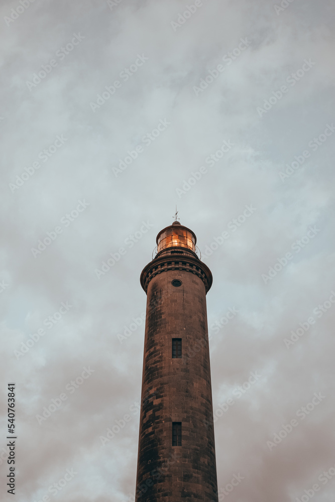 Lighthouse against cloudy gray sky Lighthouse against cloudy gray sky