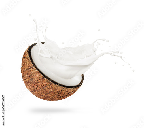 Half of a coconut with milk splashes isolated on a white background